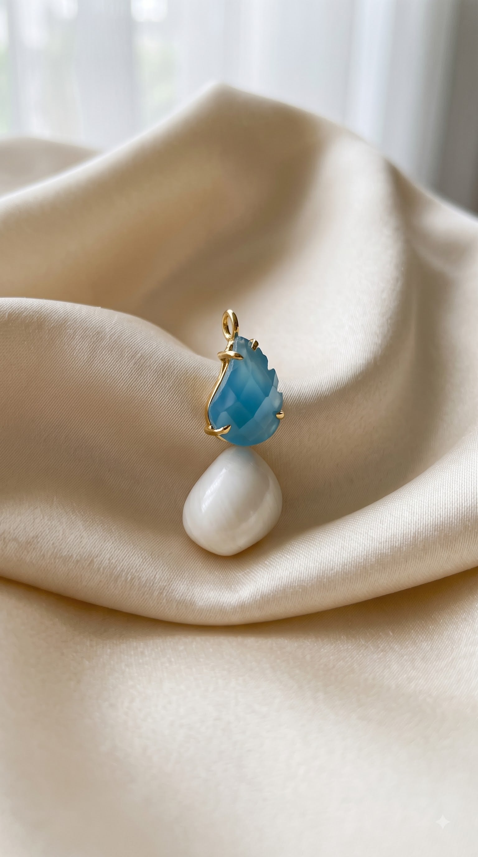 shell pendent with feather blue stone